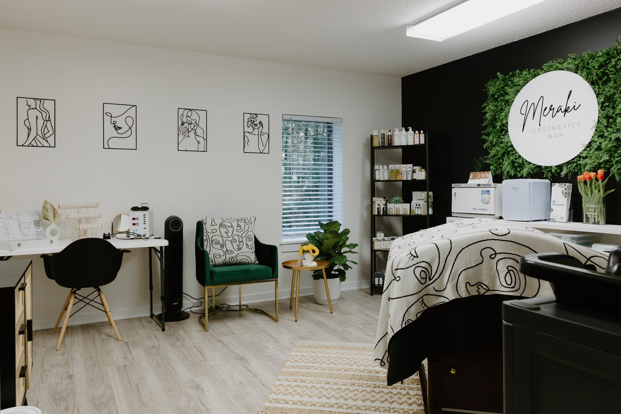 The treatment room with a bed, desk and plants